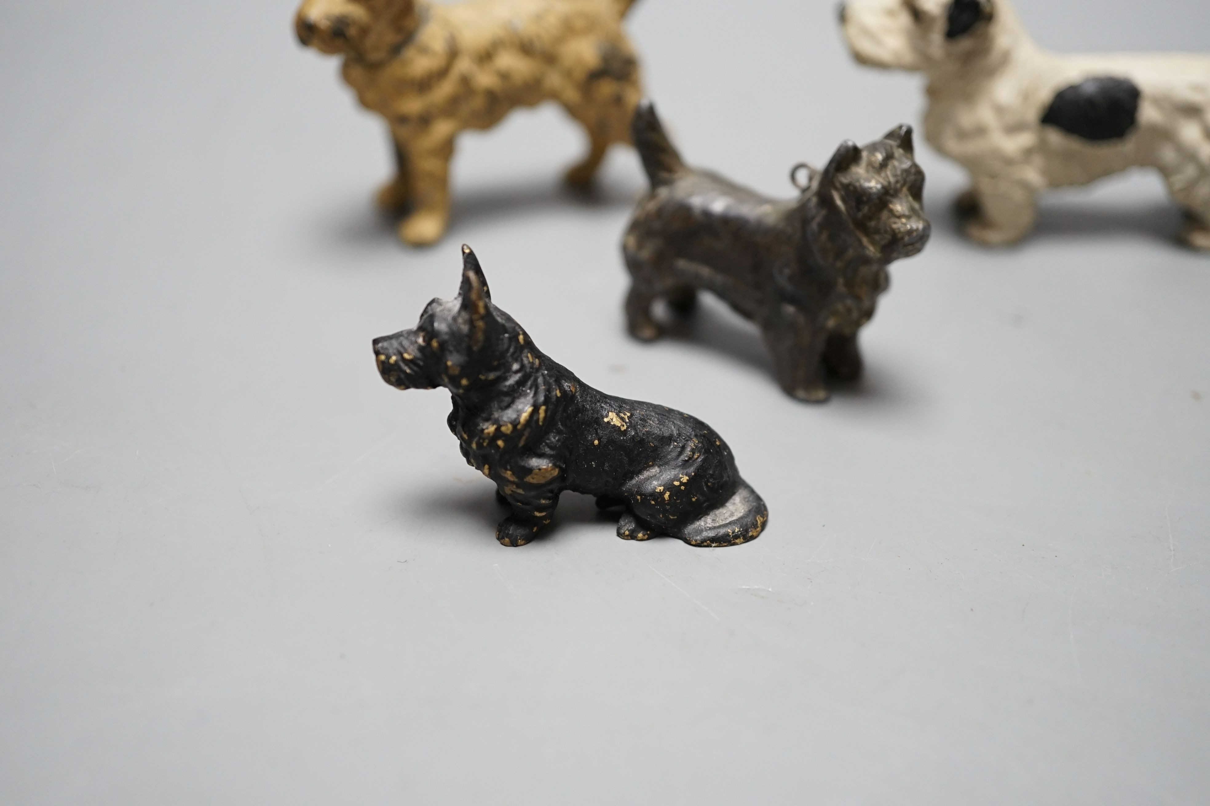 Four cold painted dogs, two bronze, tallest 5.5cm